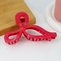Detail view of 13cm rose red bow hair claw clip with glossy finish on a wooden tray - Glossy Watermelon Red