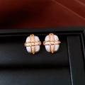Detail of gold-plated square earrings with white matte texture in a black jewelry box - Oval / Gold Plated White