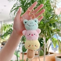 Macro shot of plush keychain with frog, pig and chick characters in a stack design - Gold Clasp / Pink