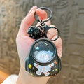 Luminous black space bear keychain with astronaut figure inside a transparent capsule - Glowing Cat Backpack - Black