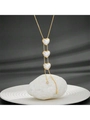 Macro detail of gold necklace with white heart pendants and zircon tassels on marble - Pearl Heart Necklace C610