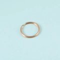 Close-up of a high-quality gold stainless steel split ring for DIY keychains - Rose Gold