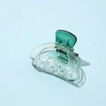 Detailed close-up of green transparent acetate hair claw clip on light blue background - Half Round Green