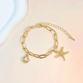 Pulsera dorada con estrella de mar, perla de concha y cadena de clips elegante - Pulsera de Estrella de Mar + Concha