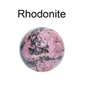 Polished natural Rhodonite crystal ball with pink and black marbled pattern texture - Rhodonite