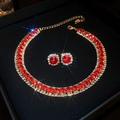 Detail of a luxury gold-plated necklace and square red gemstone earrings in a black gift box - Red Gemstone with Square Studs / Gold-Red