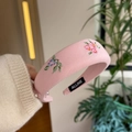 Macro detail of a pink floral embroidered padded headband with handmade stitching finish - Pink - Embroidered Flower Headband
