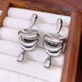 Detail view of silver drop fringe earrings featuring polished metal rings and fluid design - Silver