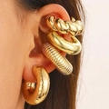 Close-up of a model wearing four different chunky gold textured ear cuffs - Golden European Style Earring Set (N-464) / Medium KC Gold / 14K Gold
