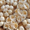 Macro view of heart-shaped gift boxes with yellow rose soap flowers and white silk ribbons - Champagne
