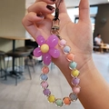 Close-up of macaron beaded phone wrist strap featuring a purple flower and colorful beads - Purple Flower Multicolor Beads