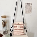 Close-up of pink striped plush crossbody bag featuring a soft texture and metal snap button - Pink White Stripes
