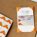 Orange self-adhesive photo corners for DIY scrapbooking displayed on brown craft paper - Orange