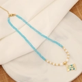 Natural stone necklace with blue faceted beads and golden heart pendant on marble tray - 1# Blue Beaded Heart Style