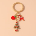 Close-up of Christmas key ring with red reindeer, green tree and apple enamel charms - Christmas Tree Apple Elk