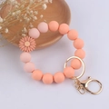 Detail of pink silicone beaded keychain bracelet with daisy charm and gold lobster clasp - Hot Pink Daisy