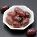 Polished egg-shaped red-brown natural agate stones set in a white ceramic bowl - Strawberry Quartz (1pc)