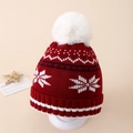 Close-up of red knit Christmas beanie with white snowflake patterns and soft pom-pom - Approx. 3-10 years old / Red