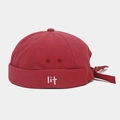 Detailed close-up of a deep red docker hat with white lit embroidery and canvas texture - Burgundy