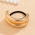 Elegant gold double-layered metallic hair ring with black elastic band on warm background - Double Layer Curved Style / Gold