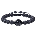 Dettaglio di perle in pietra lavica da 12mm e perla lucida su cinturino nero intrecciato - Braccialetto di Ossidiana