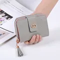 Short quilted leather wallet for women with golden buckle and tassel zip in light grey - Gray