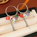 Macro detail of vintage heart crystal tassel earrings on premium jewelry box lining - Ear Buckle-Colorful