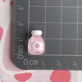 Detailed macro view of 1.5cm pink strawberry resin juice bottle on a scale cutting mat - Transparent Deep Pink Strawberry Juice