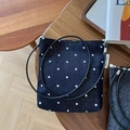 Detail of blue polka dot denim crossbody bag with zipper and Simple Wish side label - Blue Polka Dot