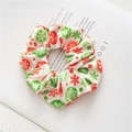 Detailed view of plush Christmas scrunchies with snowflake prints on a magazine - White Snowflake