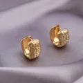 Elegant gold-plated hoop earrings with woven texture on luxury grey silk fabric - Granular Woven Hoop / E-088---Gold