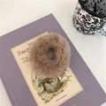 Plush brown faux fur scrunchie hair tie on purple book, cozy autumn hair accessory - Camel