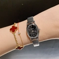 Elegant silver steel quartz watch with black oval dial and clover bracelet on wrist - Metal Elastic Strap / Silver/Black Dial