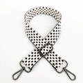 Detail of adjustable woven shoulder strap with black and white star pattern and metal clips - Silver Buckle/Houndstooth / White
