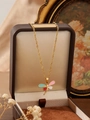Detailed close-up of a colorful enamel dragonfly pendant on a golden wave chain - Zhn741彩2