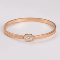 Detail of rose gold stainless steel bracelet with frosted finish and heart charm - Rose Gold