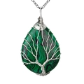 Macro shot of malachite stone pendant with silver wire tree of life wrap on white background - Malachite Silver