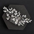 Macro detail of bridal hair comb with silver wires, crystals, and white pearls on black base - Silver Pointed Drill