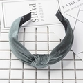 Top view of grey velvet knotted headband on a clean white tile backdrop for autumn fashion - Gray