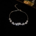 Macro detail of gold flower bracelet with marquise zircon leaves and lobster clasp - Silver Flower