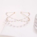 Elegant gold double-layered crisscross headband with white pearls on a white stand - Gold