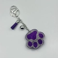 Close-up of purple rhinestone paw keychain with matching silk tassel and silver bell - Purple