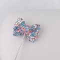 Sparkling pink and blue bow pendant with colorful rhinestones on silver metal stem - Pink and Blue AB