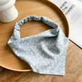 Detail of blue floral chiffon headscarf placed on a wooden tray for a rustic aesthetic - Blue