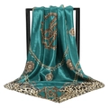 Deep green satin scarf with leopard print and golden chain pattern hanging on a stand - 90x90cm / Teal