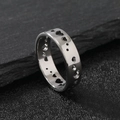 Polished titanium steel ring featuring hollow heart shapes on textured black stone - US 6 / Steel