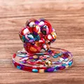Cat paw resin decor with colorful shell stones on a warm wooden background - Colorful Shell