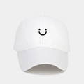 Close-up of white cotton baseball cap featuring black smiley face embroidery detail - Adjustable / White