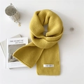 Thick ginger yellow knitted scarf with stylish brand patch on a minimalist white background - Yellow