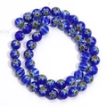 Macro detail of dark blue millefiori glass beads with intricate floral patterns - Blue Yellow Flower